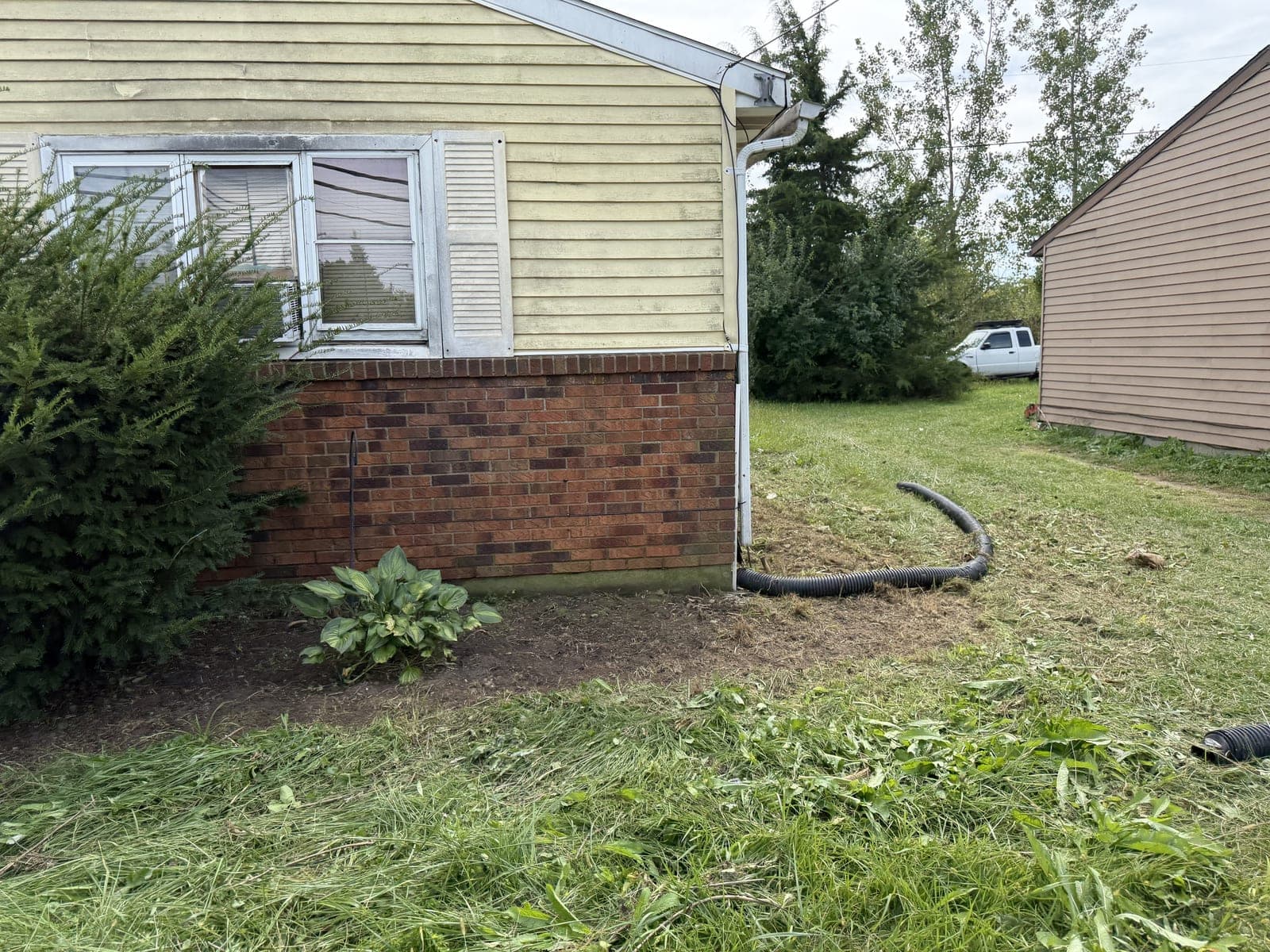 Beds and lawn cleaned up along a home